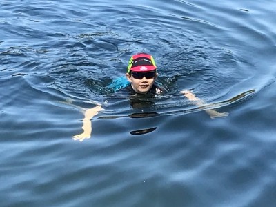 Nicky swimming with hat and glasses.jpeg